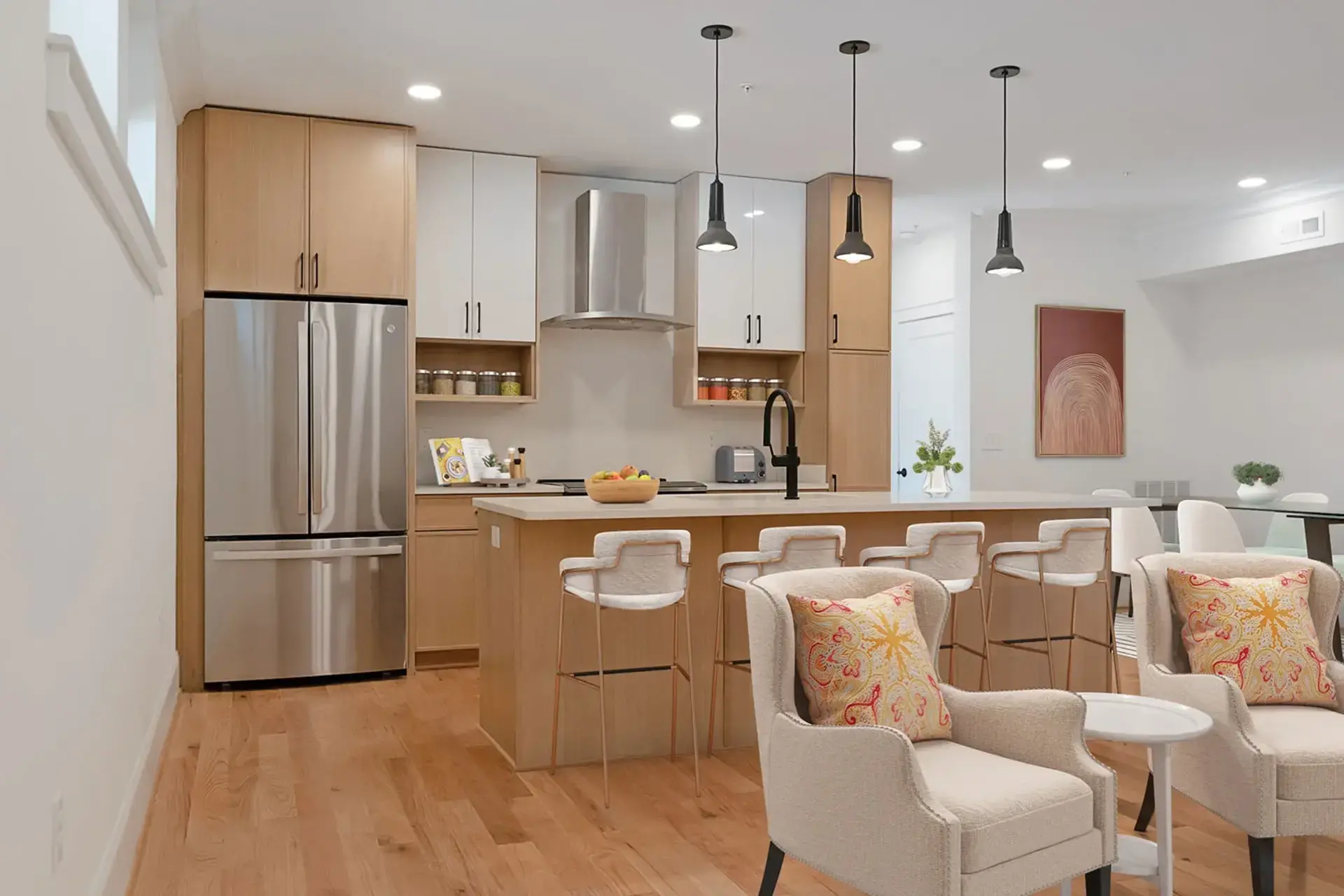 The Abby kitchen island with pendant lights and stainless steel appliances