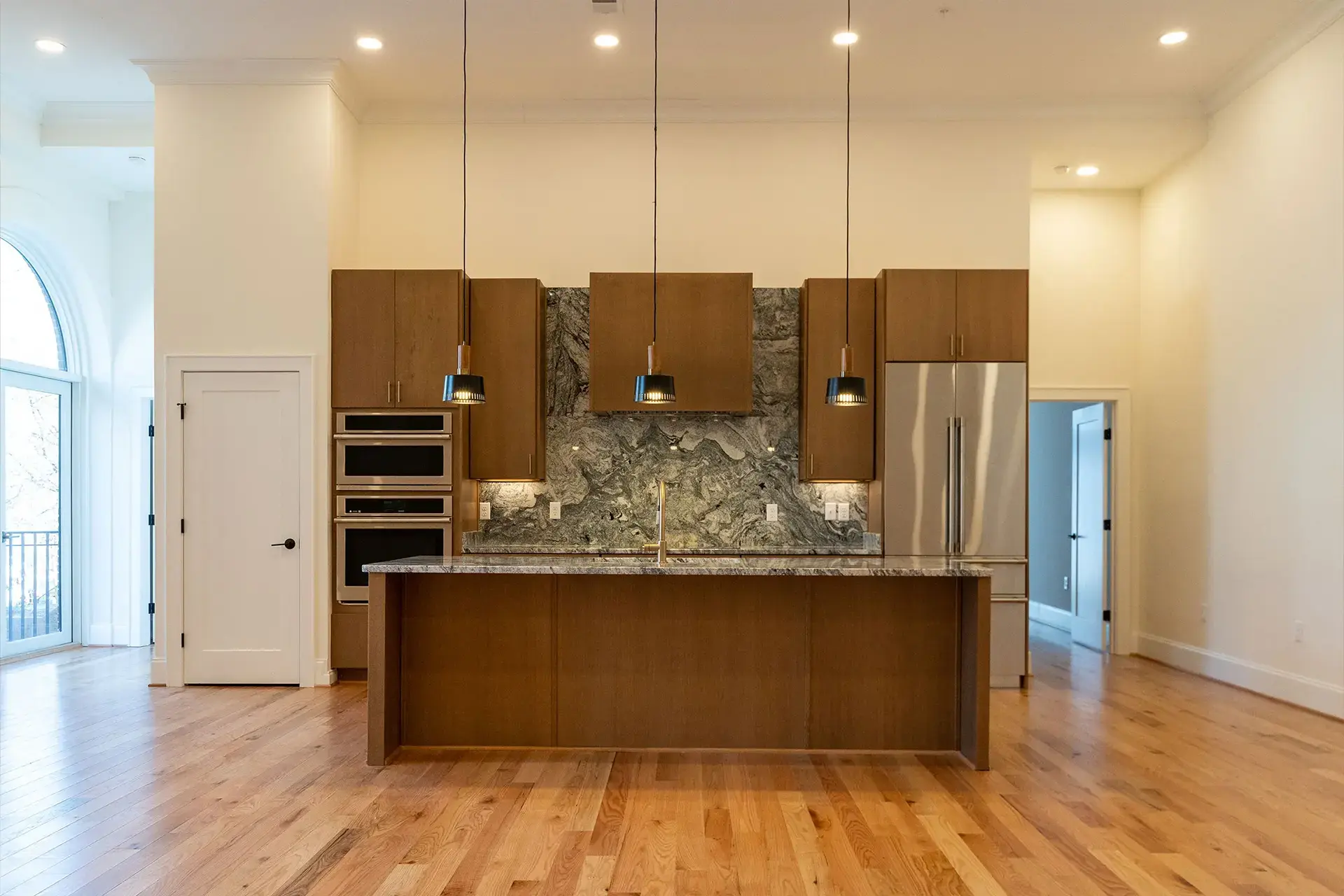 The Abby kitchen island with modern cabinets and granite counters