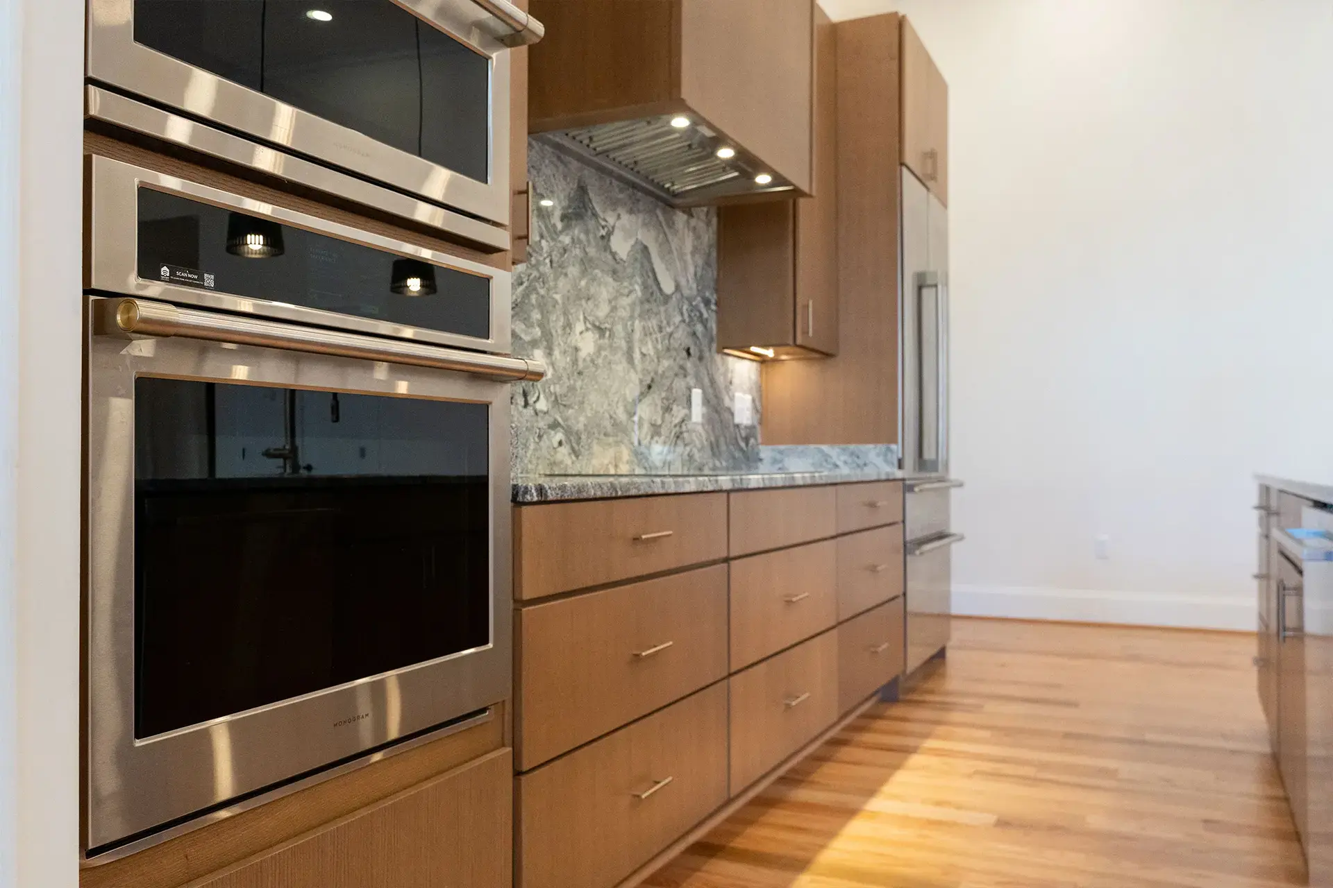 The Abby kitchen with stainless steel appliances, granite counters and modern cabinets