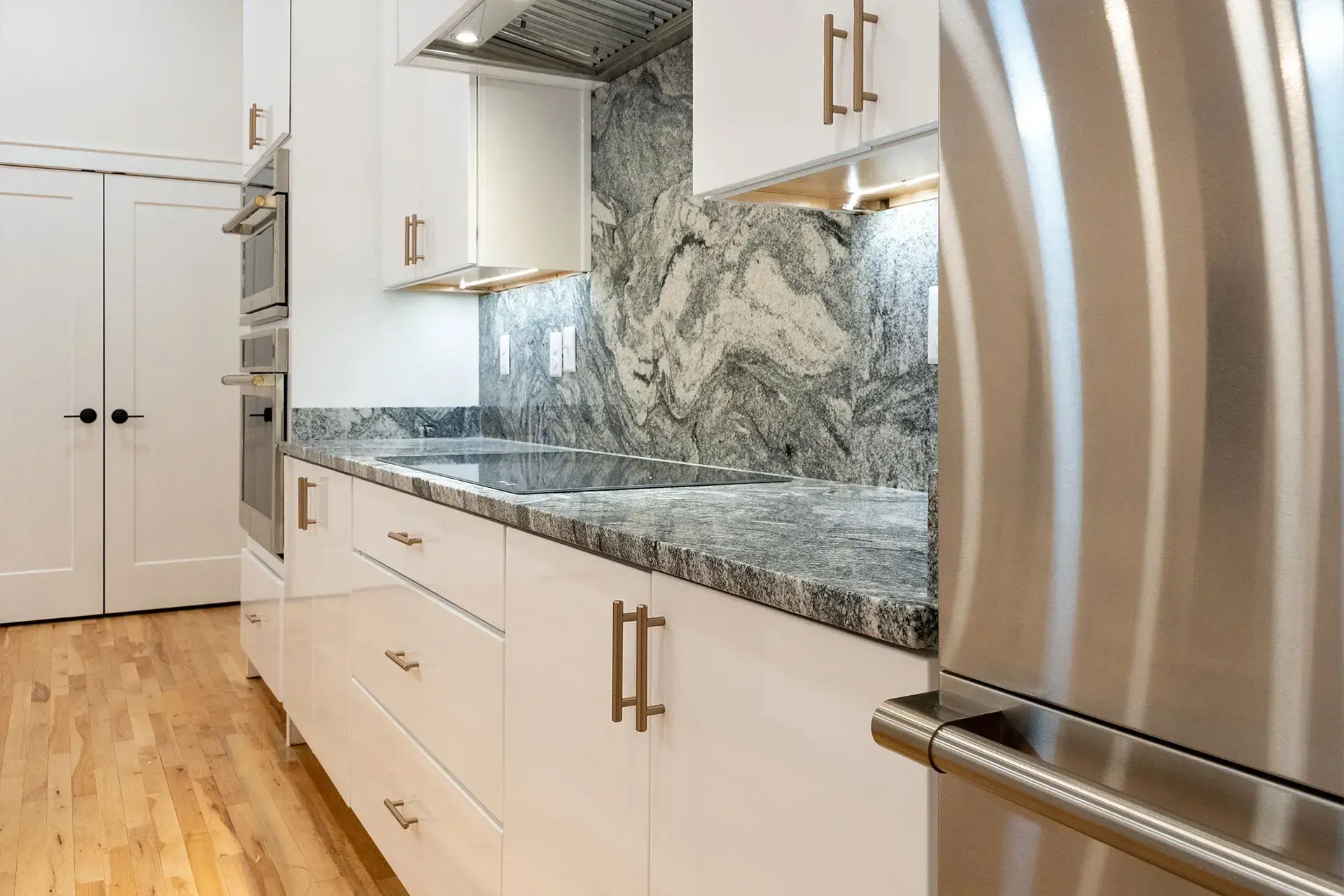 The Abby close up of granite counters and modern cabinets