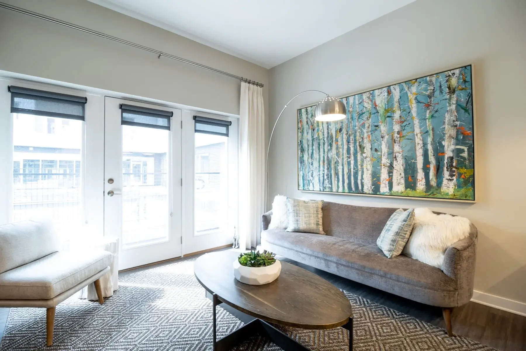 The Penny at Jackson Ward living room with seating and large painting