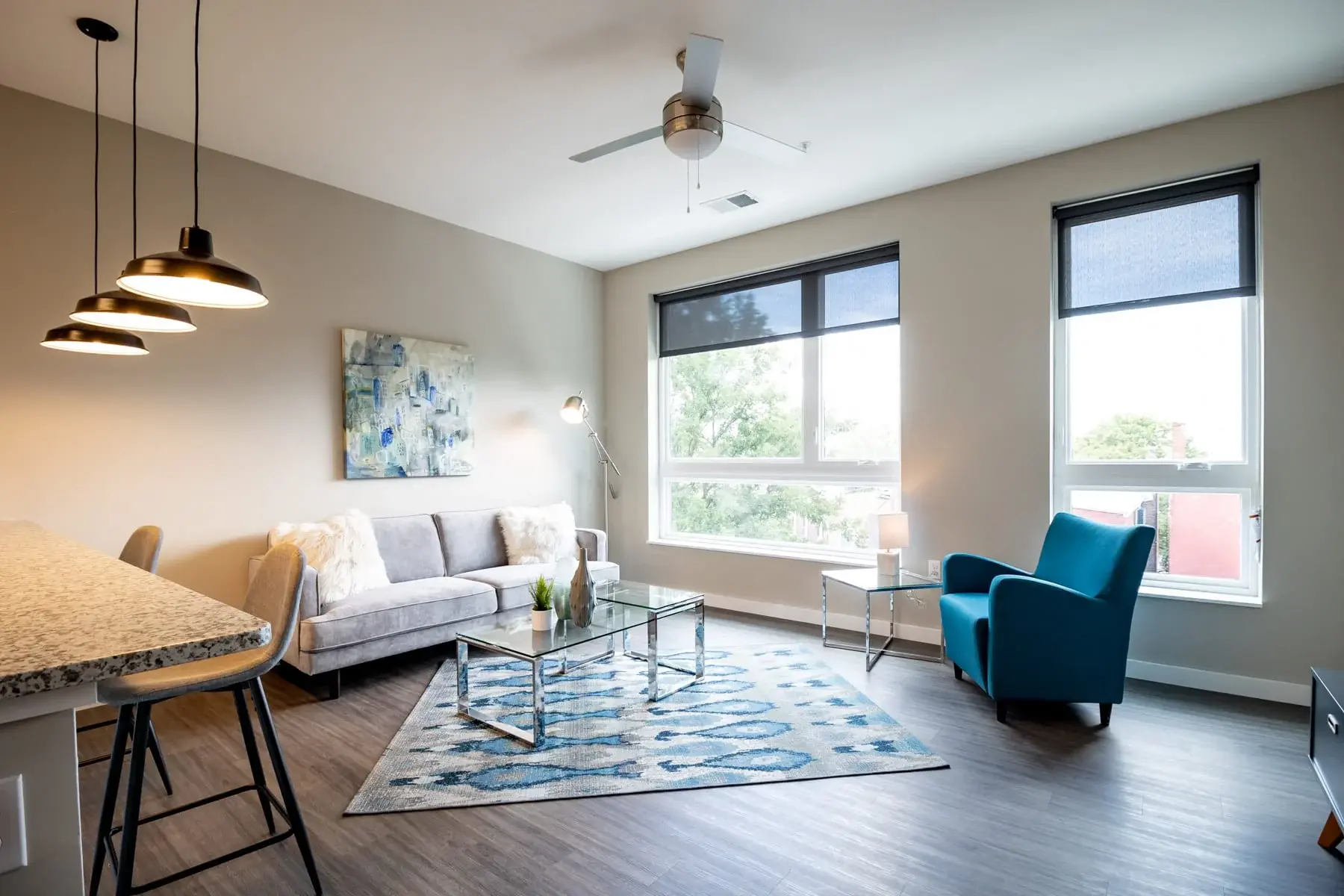 The Penny at Jackson Ward luxury condo living room with blue chair