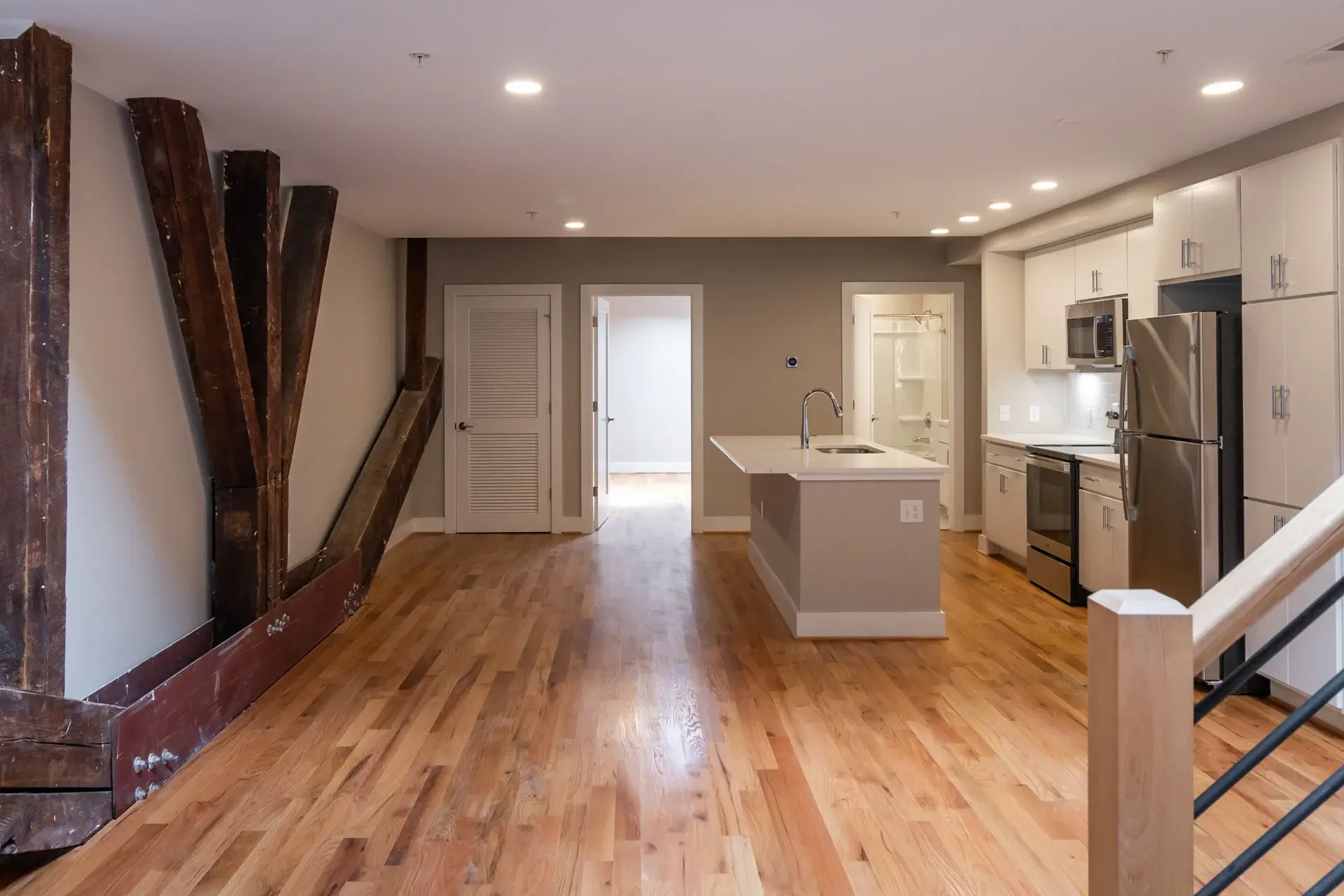Living room and kitchen area in a condo at The Watkins