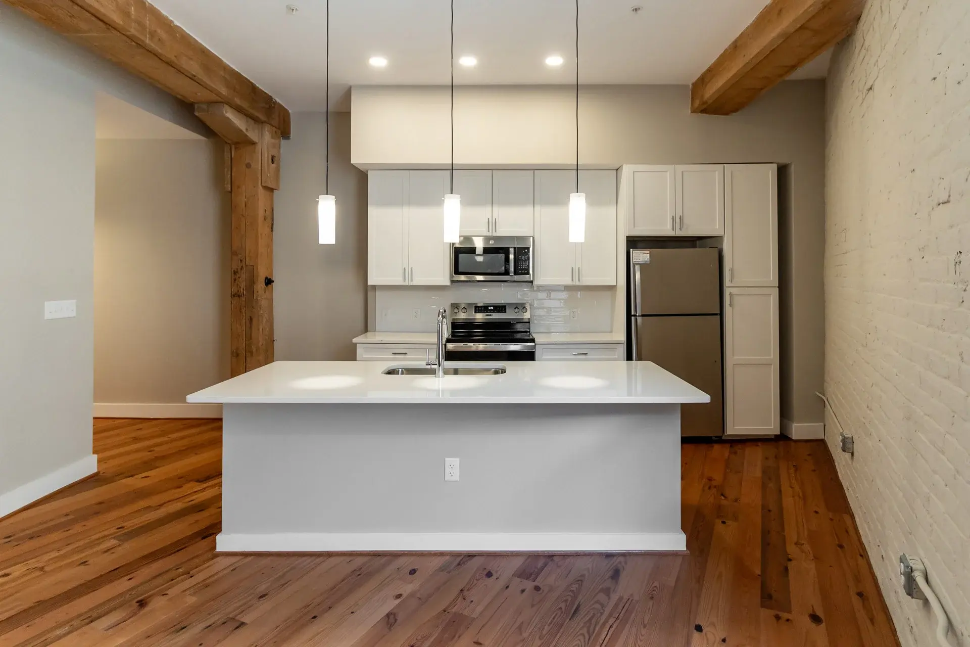 Kitchen island with pendant lighting at The Watkins