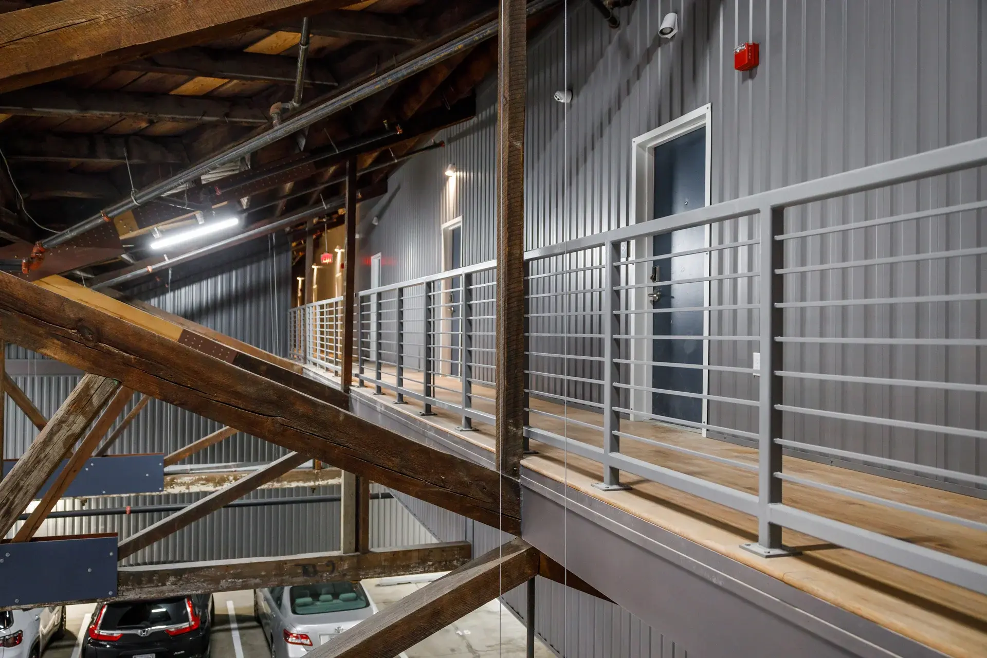 The Watkins hallway, metal railings and exposed wooden beams